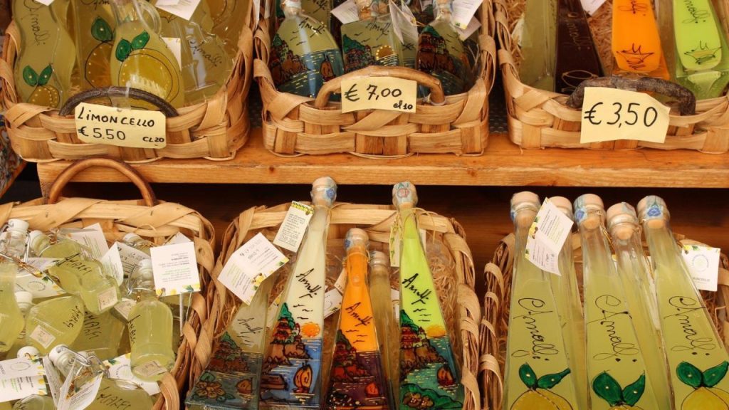 Wicker baskets filled with hand‑painted limoncello bottles.