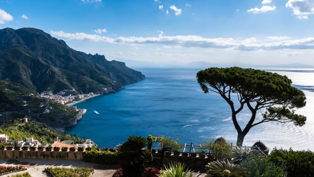 Ravello garden terrace overlooking sea, mountains, and town.